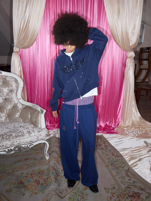 WARLORDKID dark navy sequin and bead embroidered double-zip hoodie, front view on model with one arm raised.